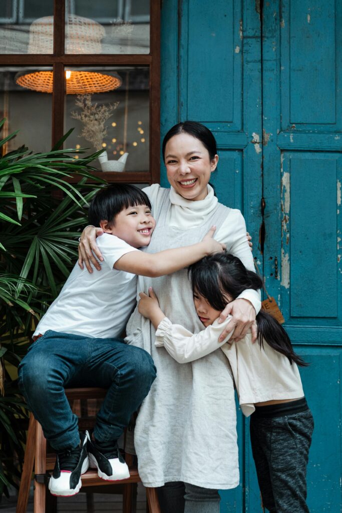 mother and children embracing in a peaceful family home.